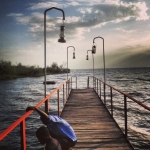 Two young men fishing on a small dock off Lake Victoria. (Image taken with Instagram)